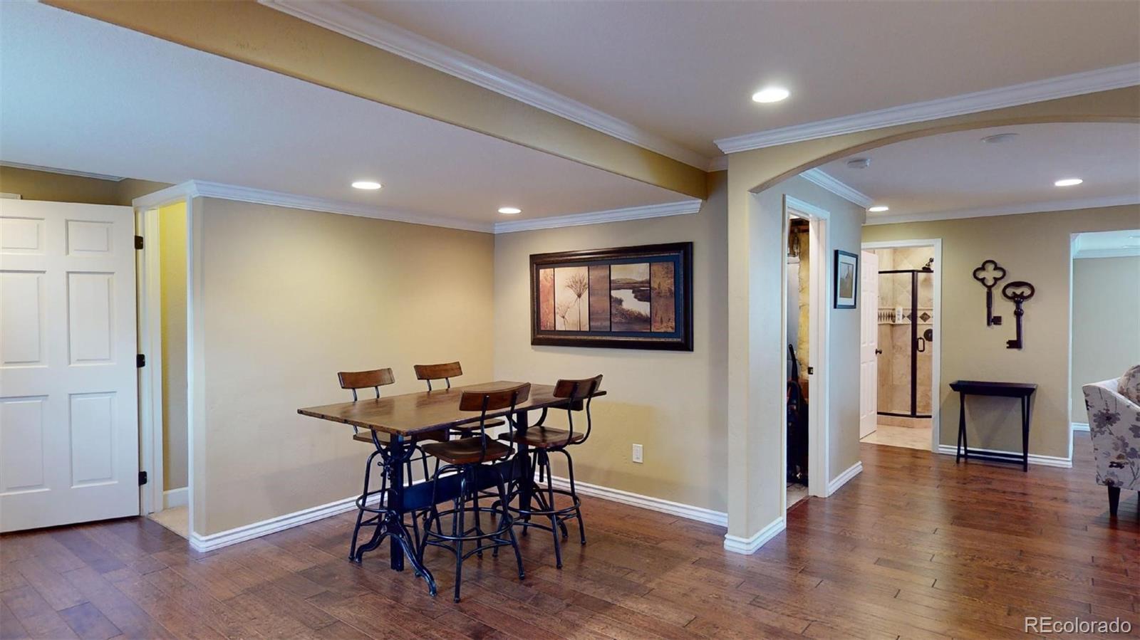 599 Timbervale Trail Highlands Ranch, CO 80129 - Photo 23 of 32 a view of a dining room with furniture and wooden floor