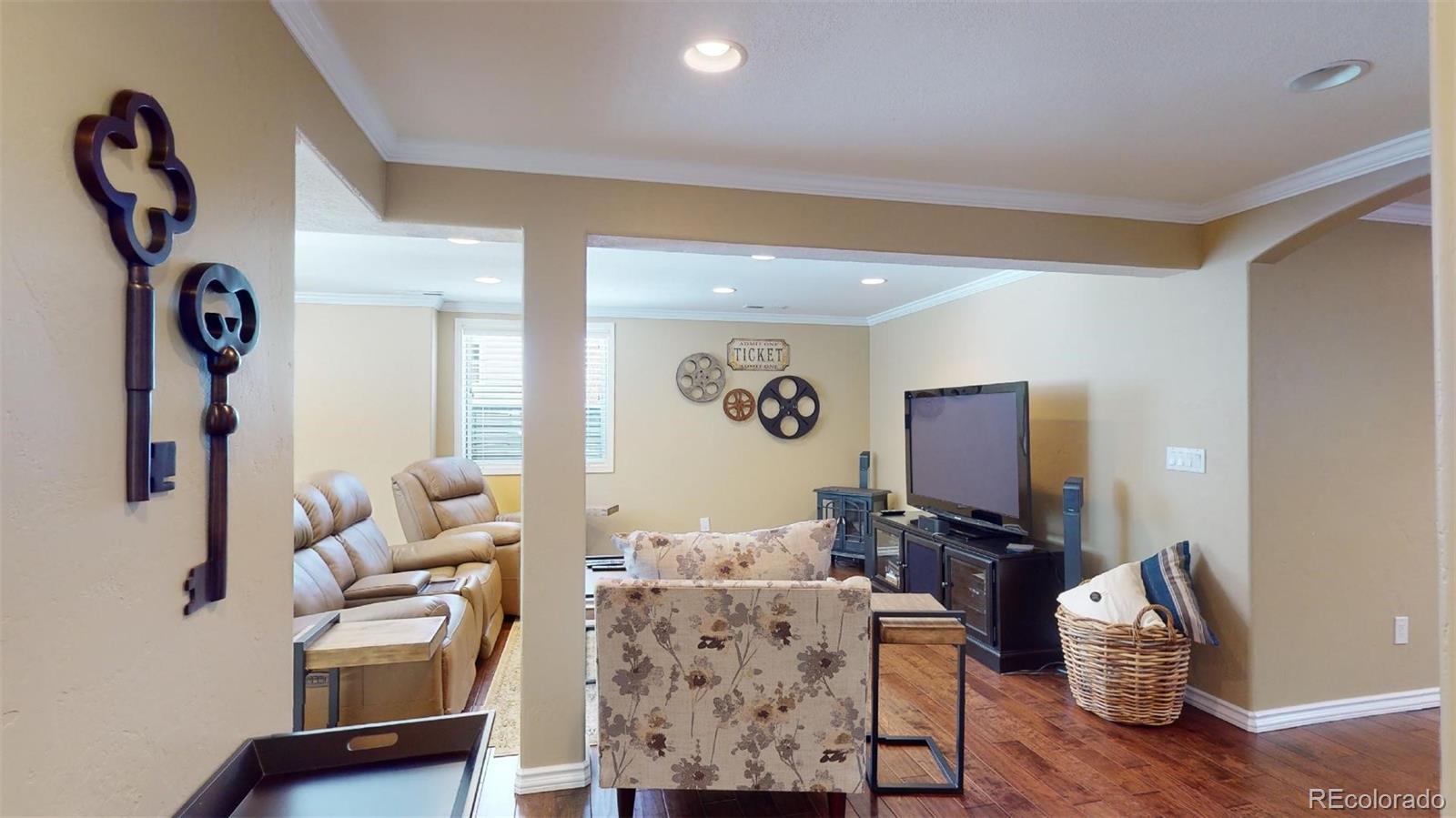 599 Timbervale Trail Highlands Ranch, CO 80129 - Photo 25 of 32 a living room with furniture a rug and a flat screen tv