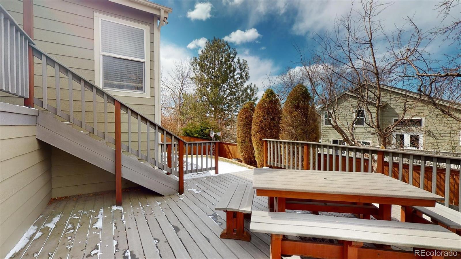 599 Timbervale Trail Highlands Ranch, CO 80129 - Photo 28 of 32 a balcony with wooden floor stairs and furniture