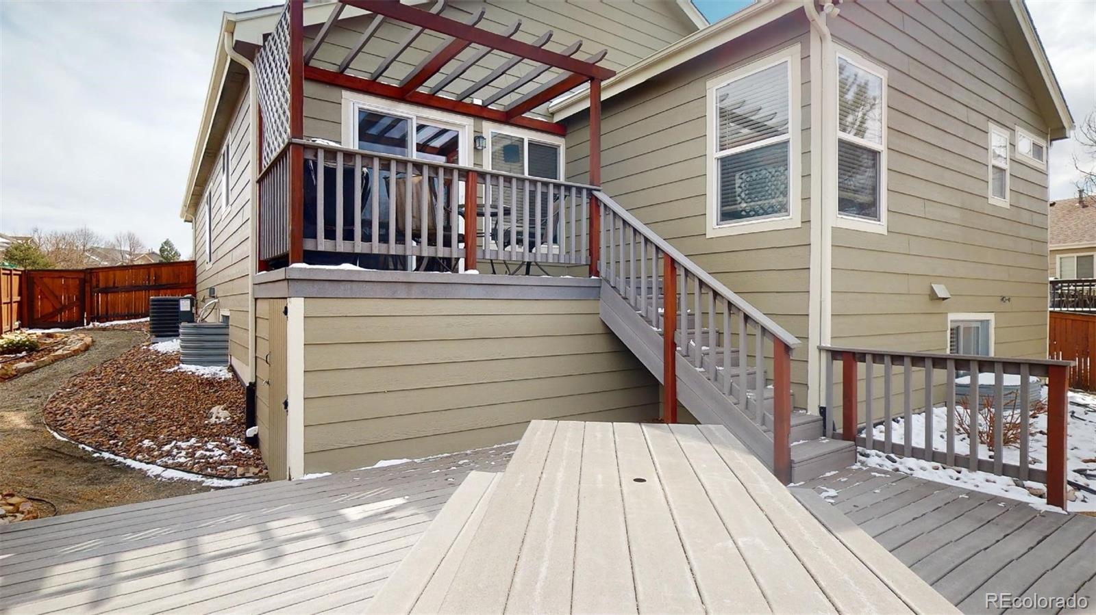 599 Timbervale Trail Highlands Ranch, CO 80129 - Photo 29 of 32 a view of a wooden deck front of house