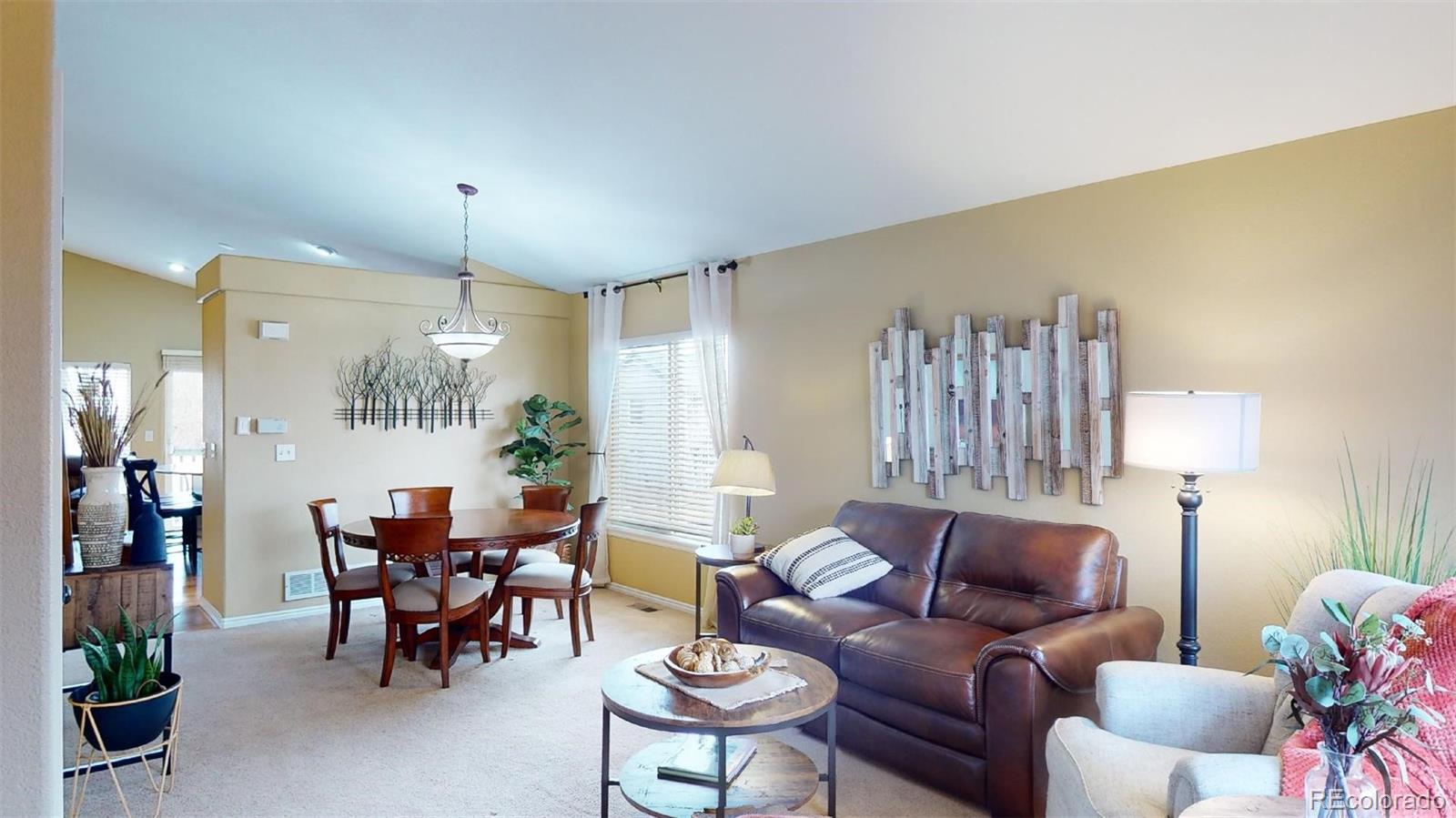 599 Timbervale Trail Highlands Ranch, CO 80129 - Photo 4 of 32 a living room with furniture and a chandelier