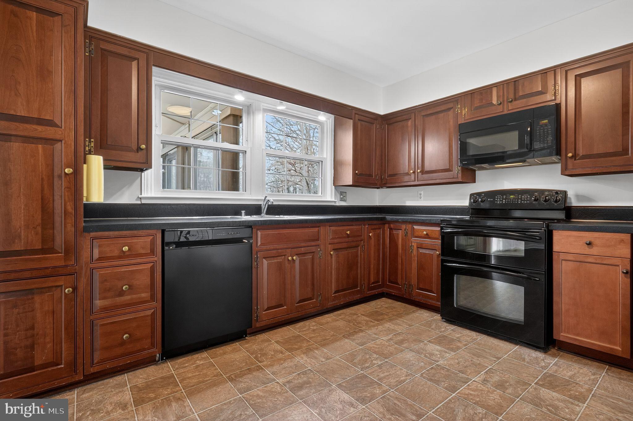 1629 Eton Way Crofton, MD 21114 - Photo 14 of 46 a kitchen with stainless steel appliances granite countertop a stove cabinets and microwave
