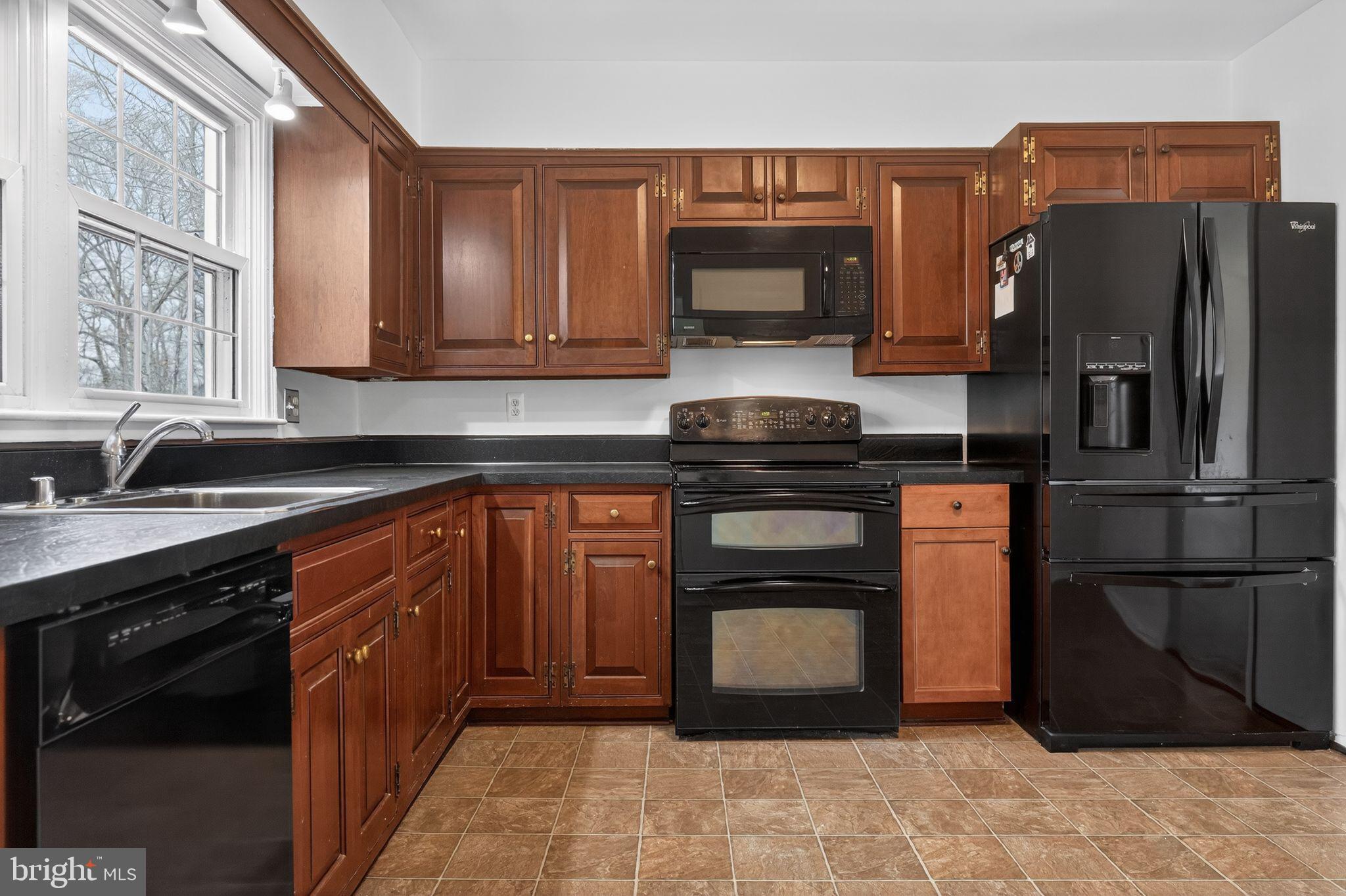 1629 Eton Way Crofton, MD 21114 - Photo 15 of 46 a kitchen with stainless steel appliances granite countertop a refrigerator stove and sink