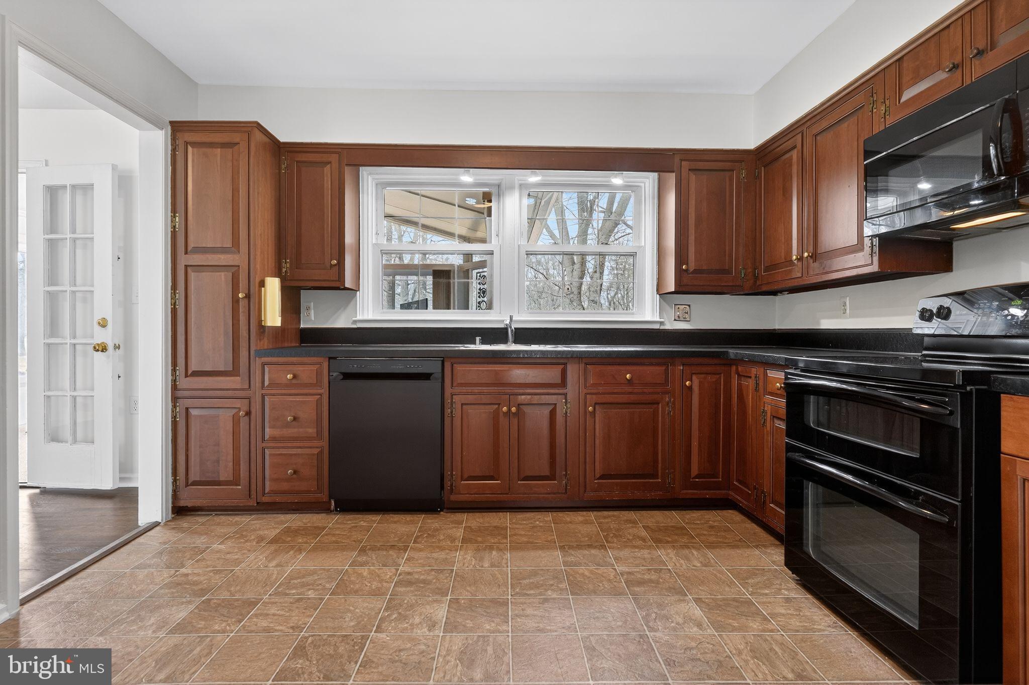 1629 Eton Way Crofton, MD 21114 - Photo 16 of 46 a kitchen with a stove top oven sink and cabinets