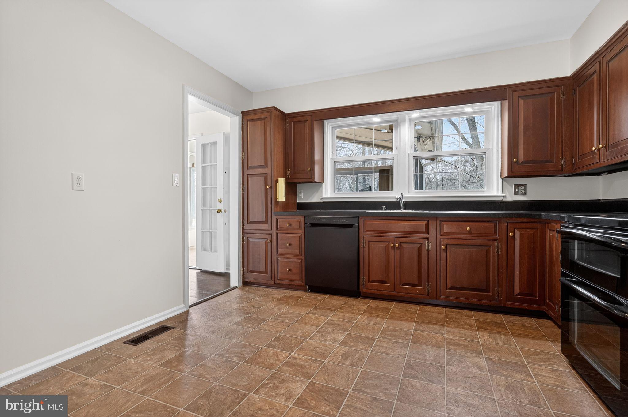 1629 Eton Way Crofton, MD 21114 - Photo 17 of 46 a kitchen with granite countertop a stove a sink and a refrigerator