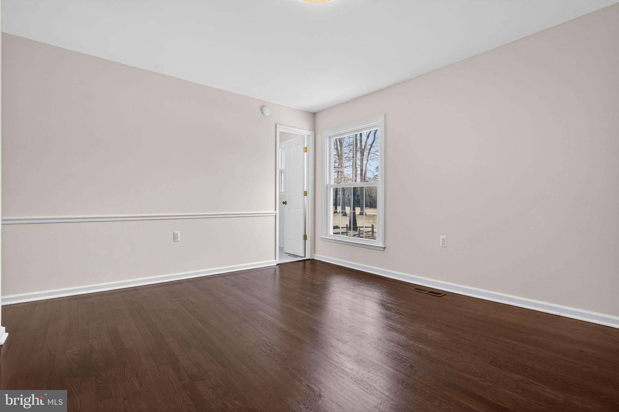 1629 Eton Way Crofton, MD 21114 - Photo 18 of 46 an empty room with wooden floor and windows