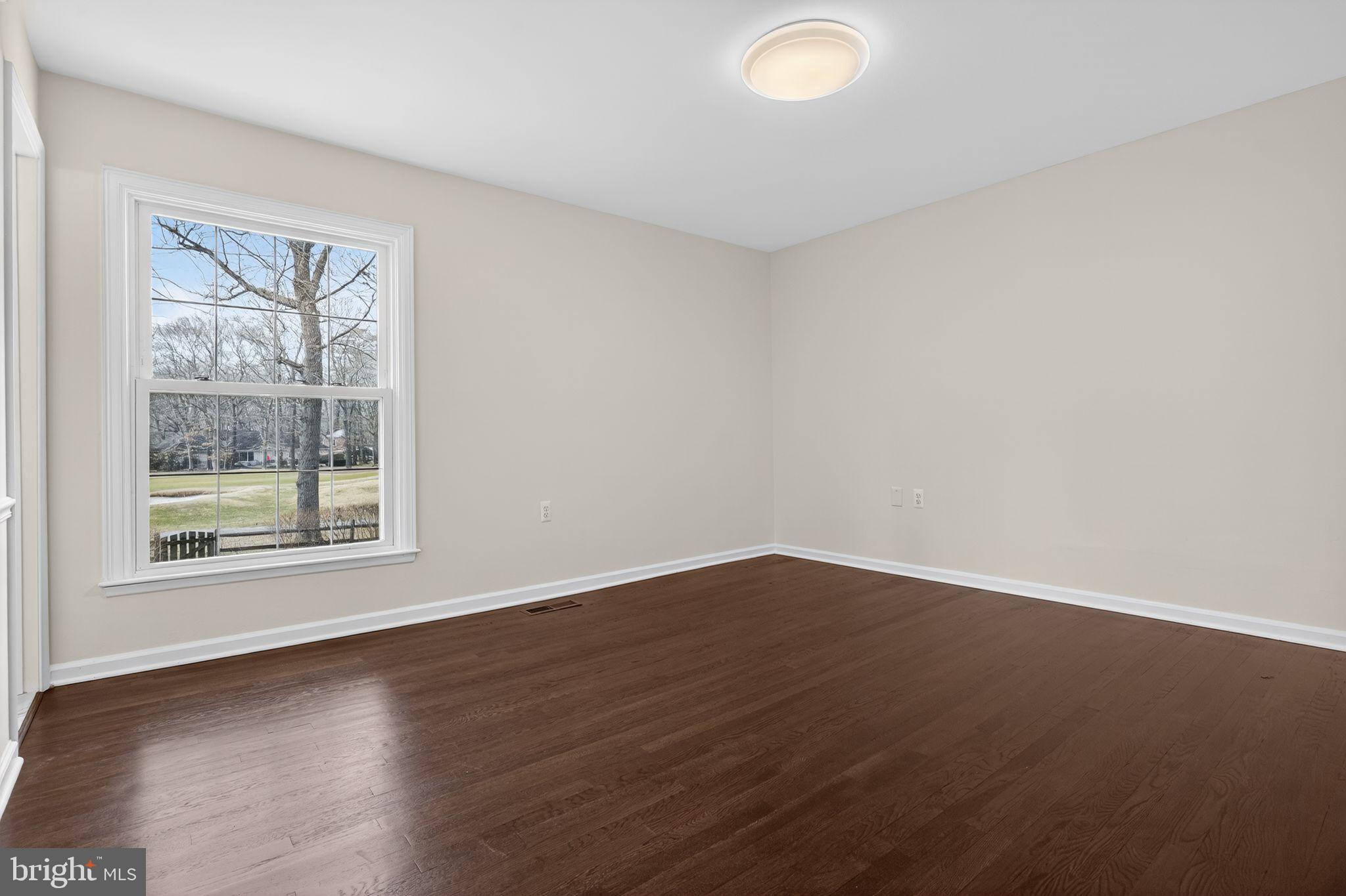 1629 Eton Way Crofton, MD 21114 - Photo 19 of 46 a view of an empty room with wooden floor and a window
