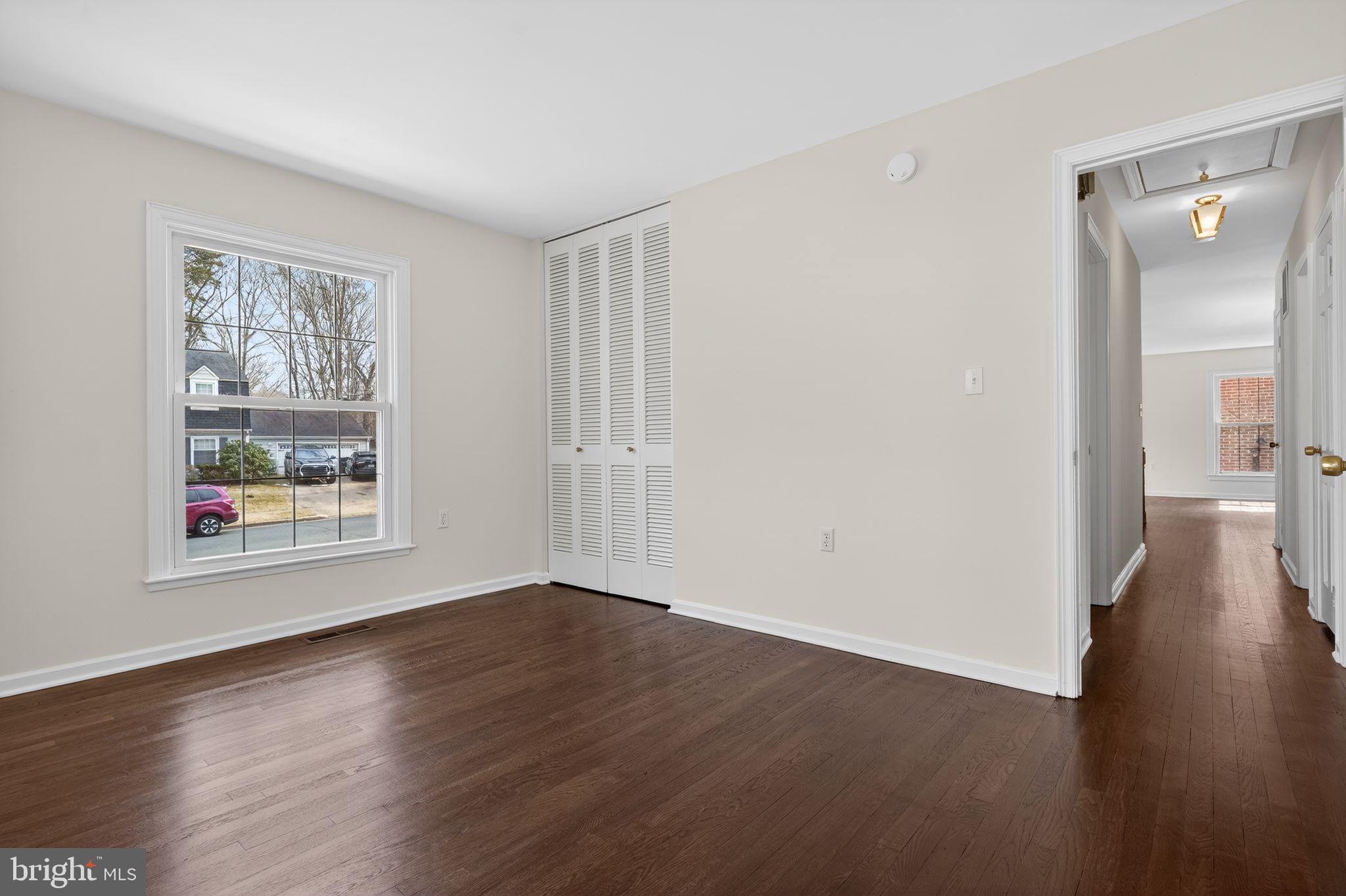 1629 Eton Way Crofton, MD 21114 - Photo 22 of 46 a view of an empty room with wooden floor and a window
