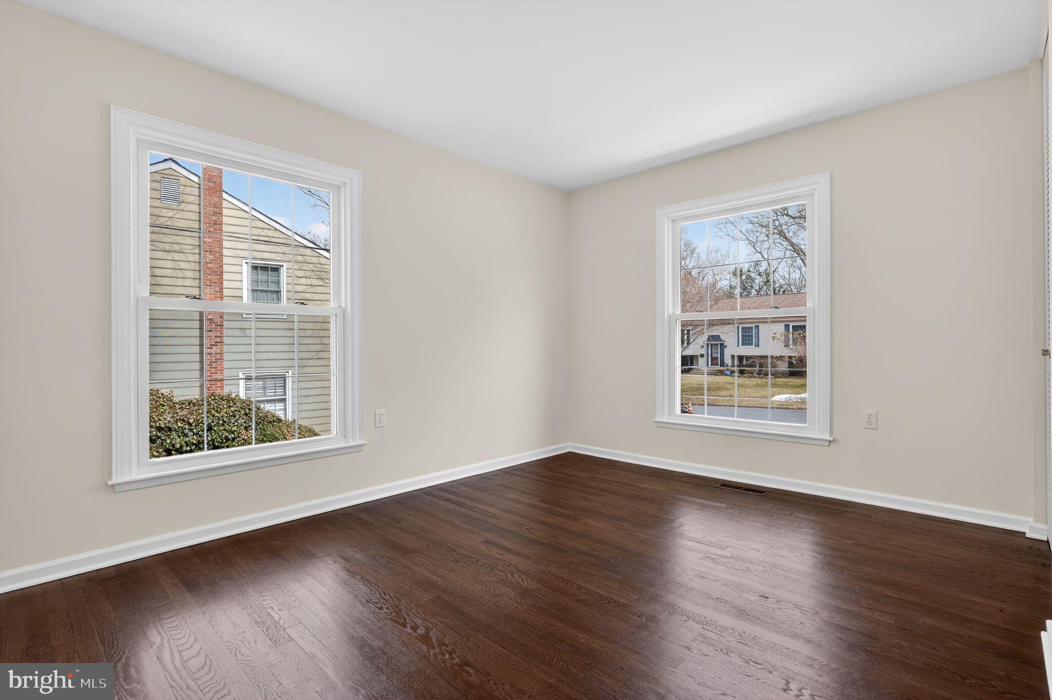 1629 Eton Way Crofton, MD 21114 - Photo 23 of 46 a view of an empty room with wooden floor and a window