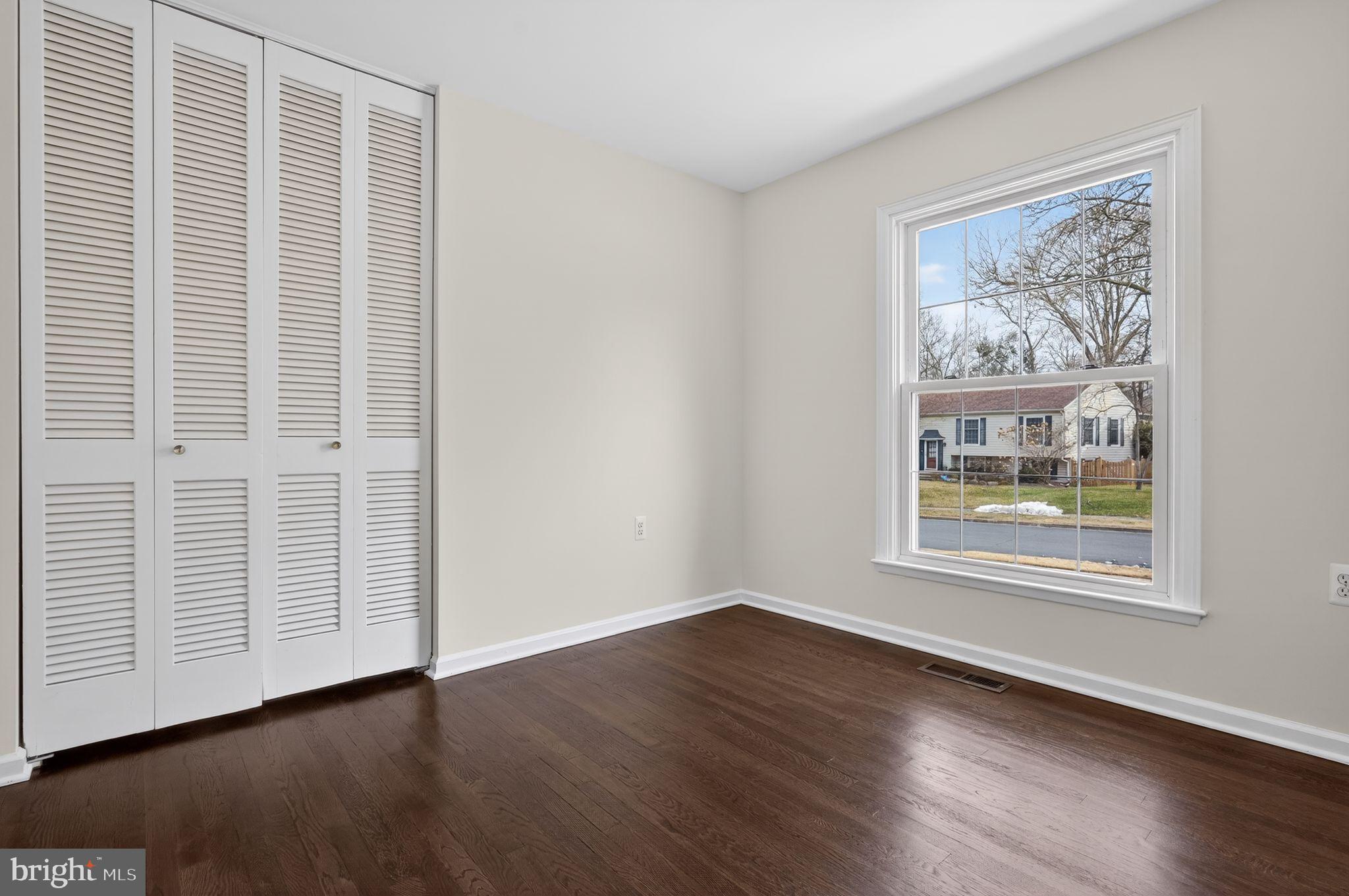 1629 Eton Way Crofton, MD 21114 - Photo 24 of 46 an empty room with wooden floor and windows