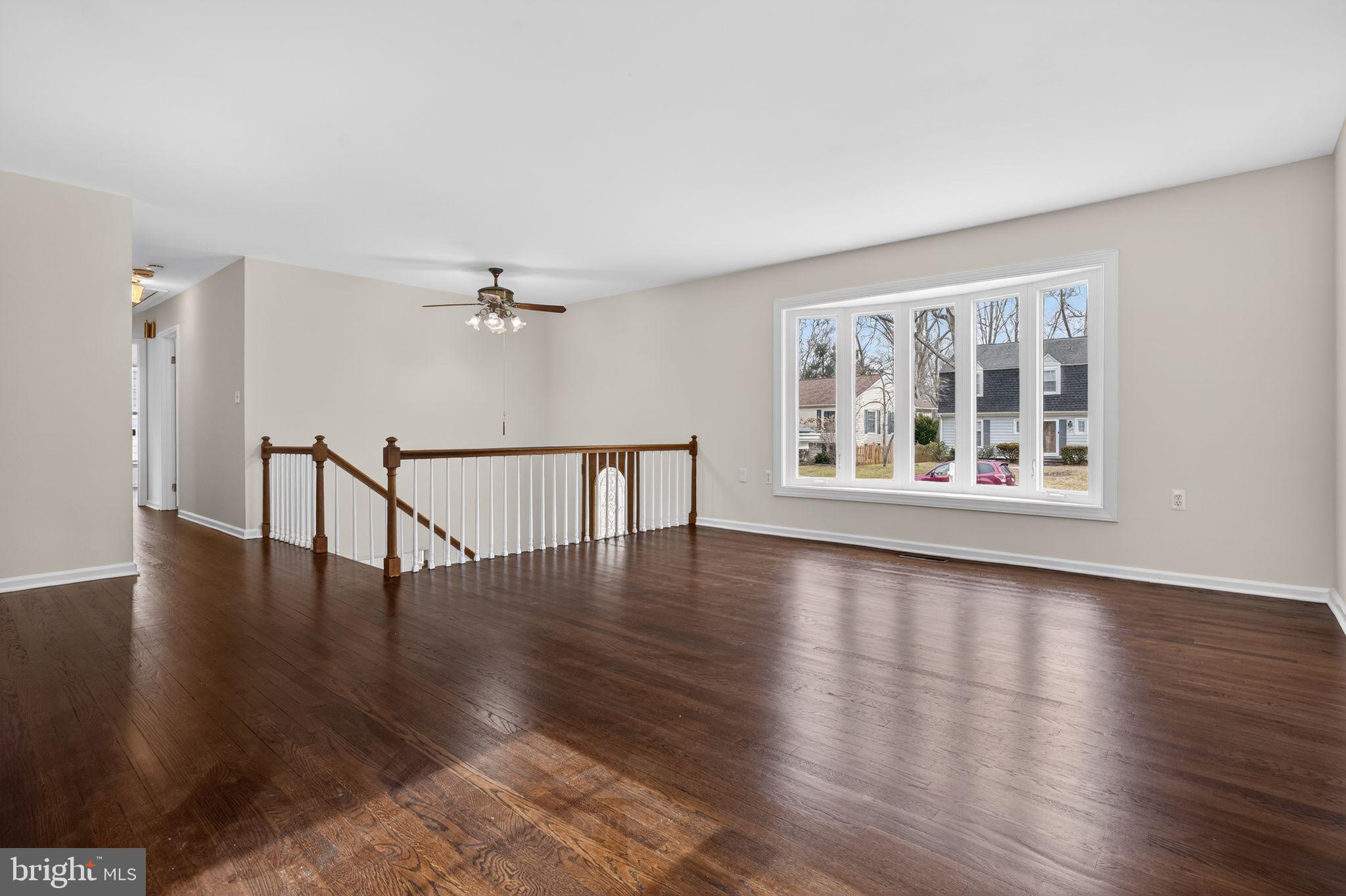 1629 Eton Way Crofton, MD 21114 - Photo 6 of 46 a view of an empty room with wooden floor and a window