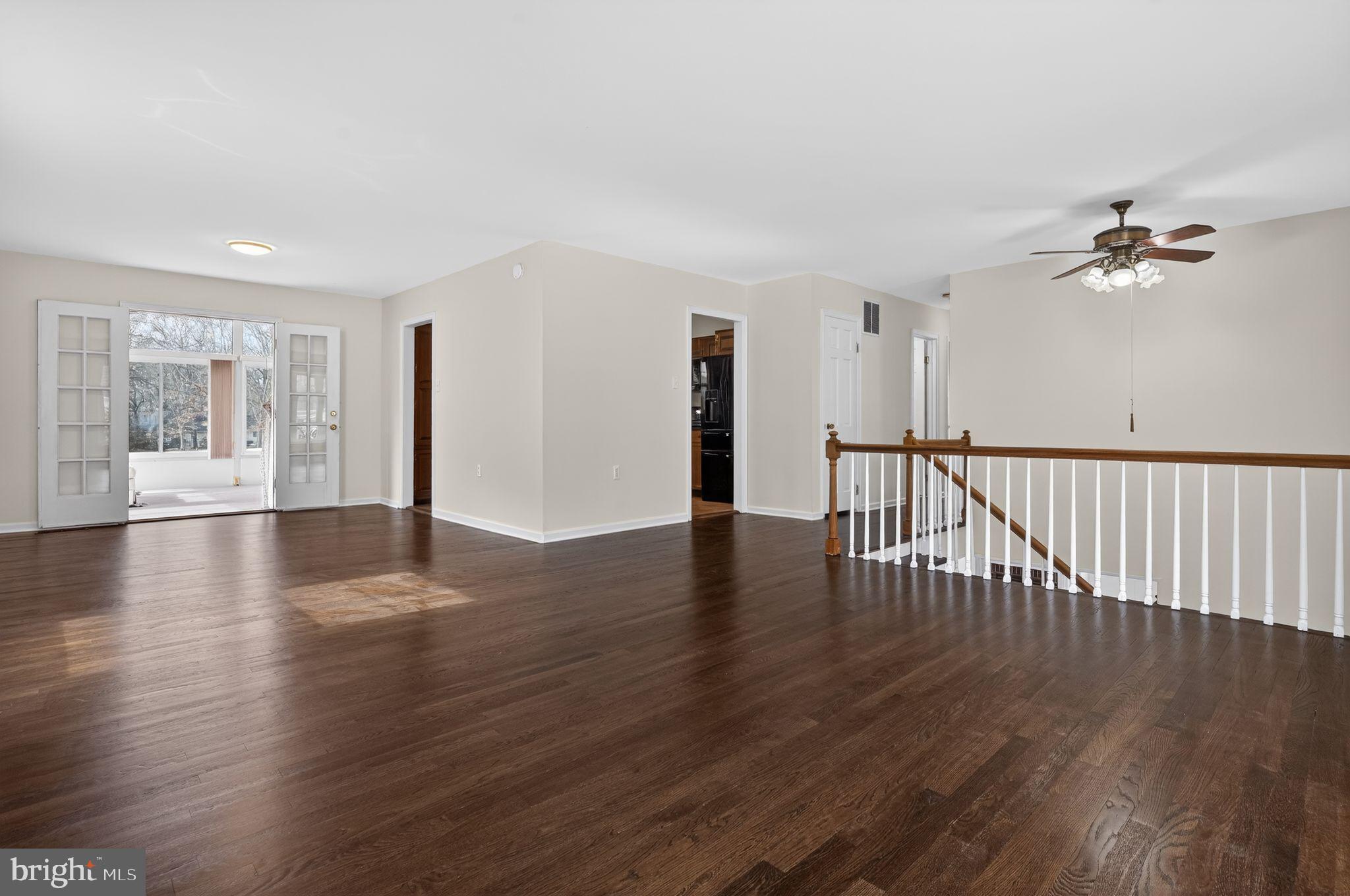 1629 Eton Way Crofton, MD 21114 - Photo 7 of 46 a view of an empty room with wooden floor and a window