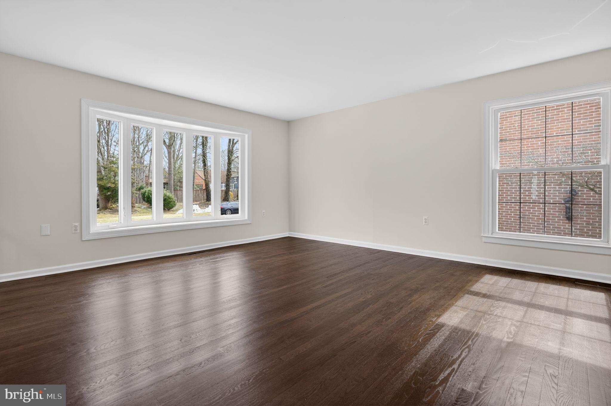 1629 Eton Way Crofton, MD 21114 - Photo 8 of 46 a view of an empty room with wooden floor and a window