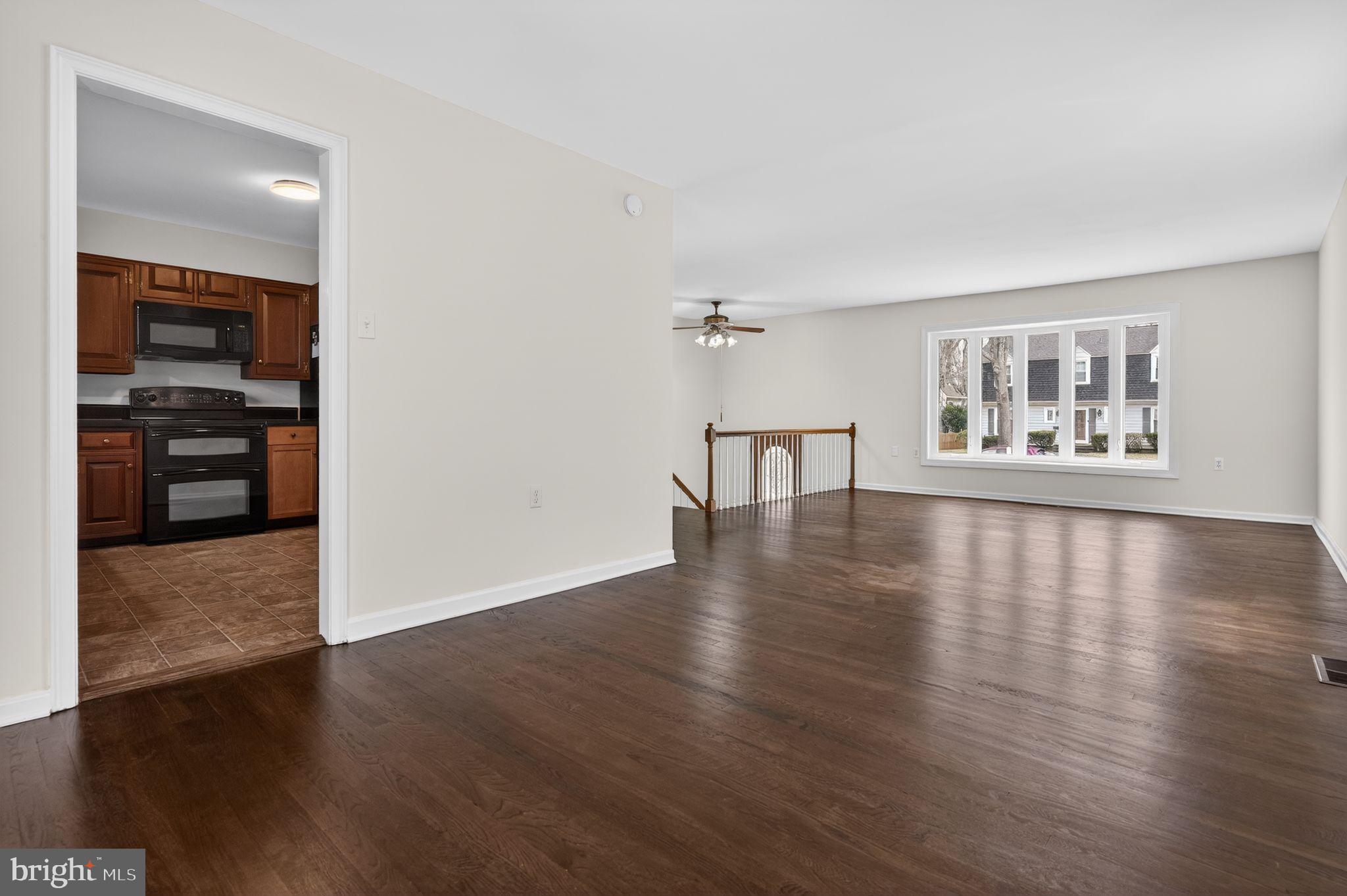 1629 Eton Way Crofton, MD 21114 - Photo 9 of 46 an empty room with wooden floor closet and windows