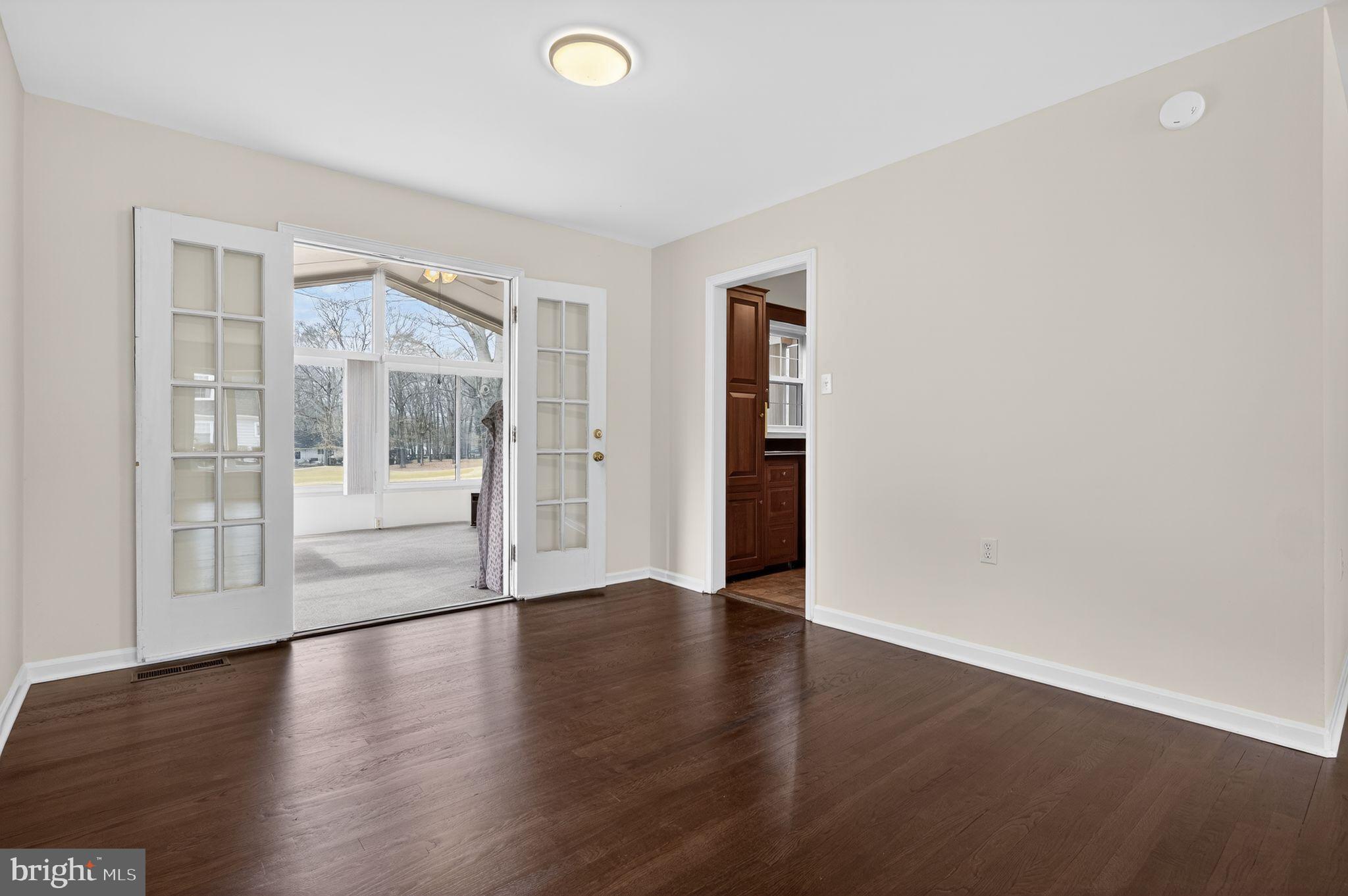 1629 Eton Way Crofton, MD 21114 - Photo 10 of 46 a view of an empty room with wooden floor and a window
