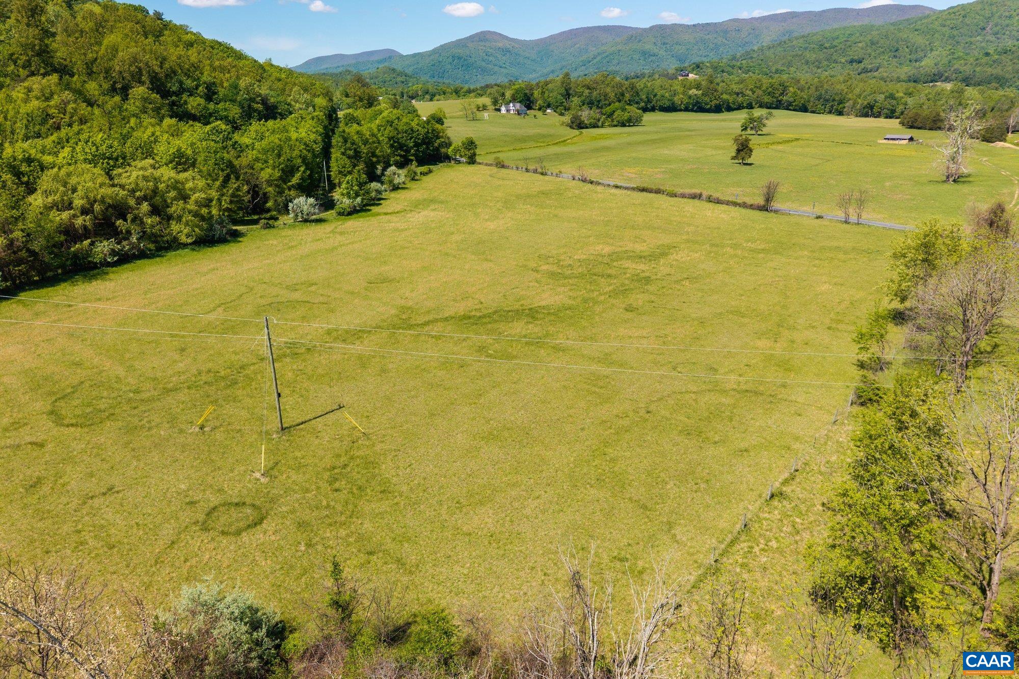2255 Boonesville Road Dyke, VA 22935 - Photo 21 of 34 a view of a lake with a mountain in the background