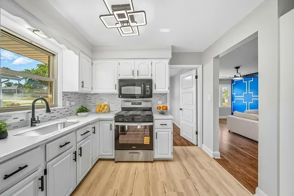 a kitchen with stainless steel appliances a white stove top oven and a refrigerator