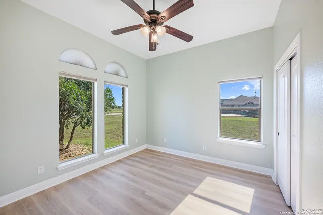 wooden floor in an empty room with a window