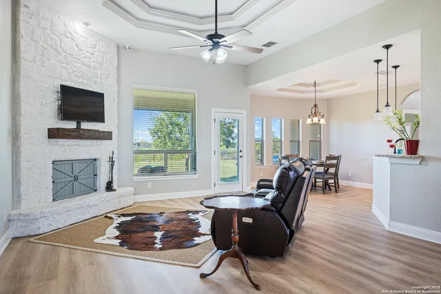 a living room with furniture fireplace and flat screen tv