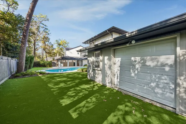 an aerial view of a house with swimming pool and porch