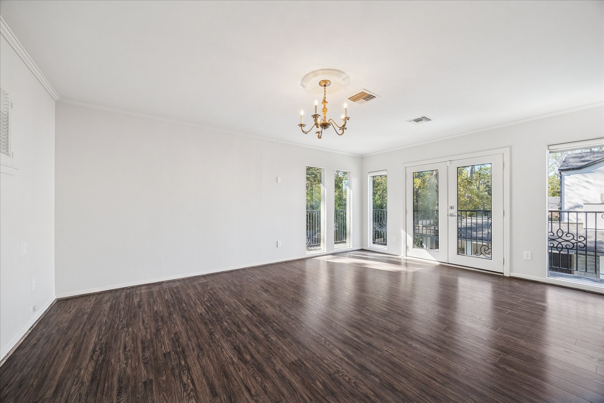 547 3 Corners Drive Hunters Creek Village, TX 77024 - Photo 2 of 17 a view of an empty room with a window and wooden floor