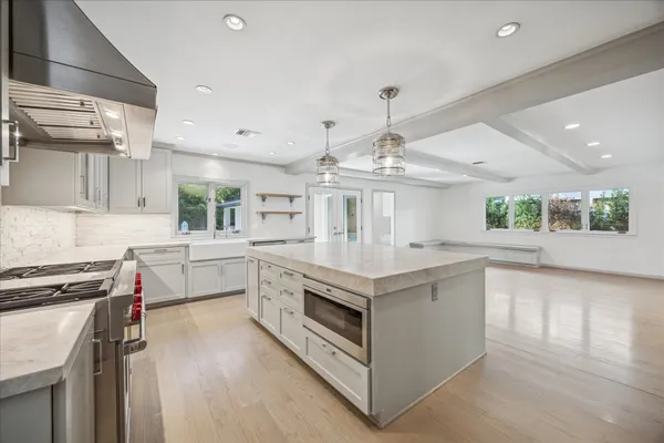 a kitchen with a stove a sink and a refrigerator