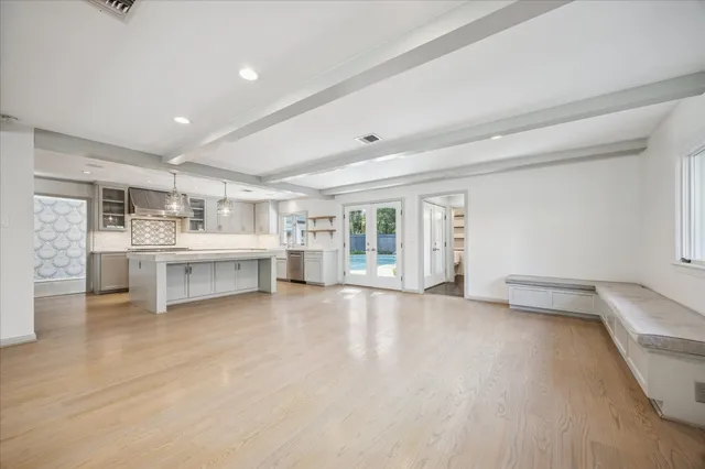 a large white kitchen with a large window