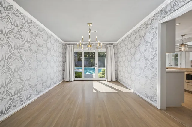 a view of an empty room with a fireplace and a window