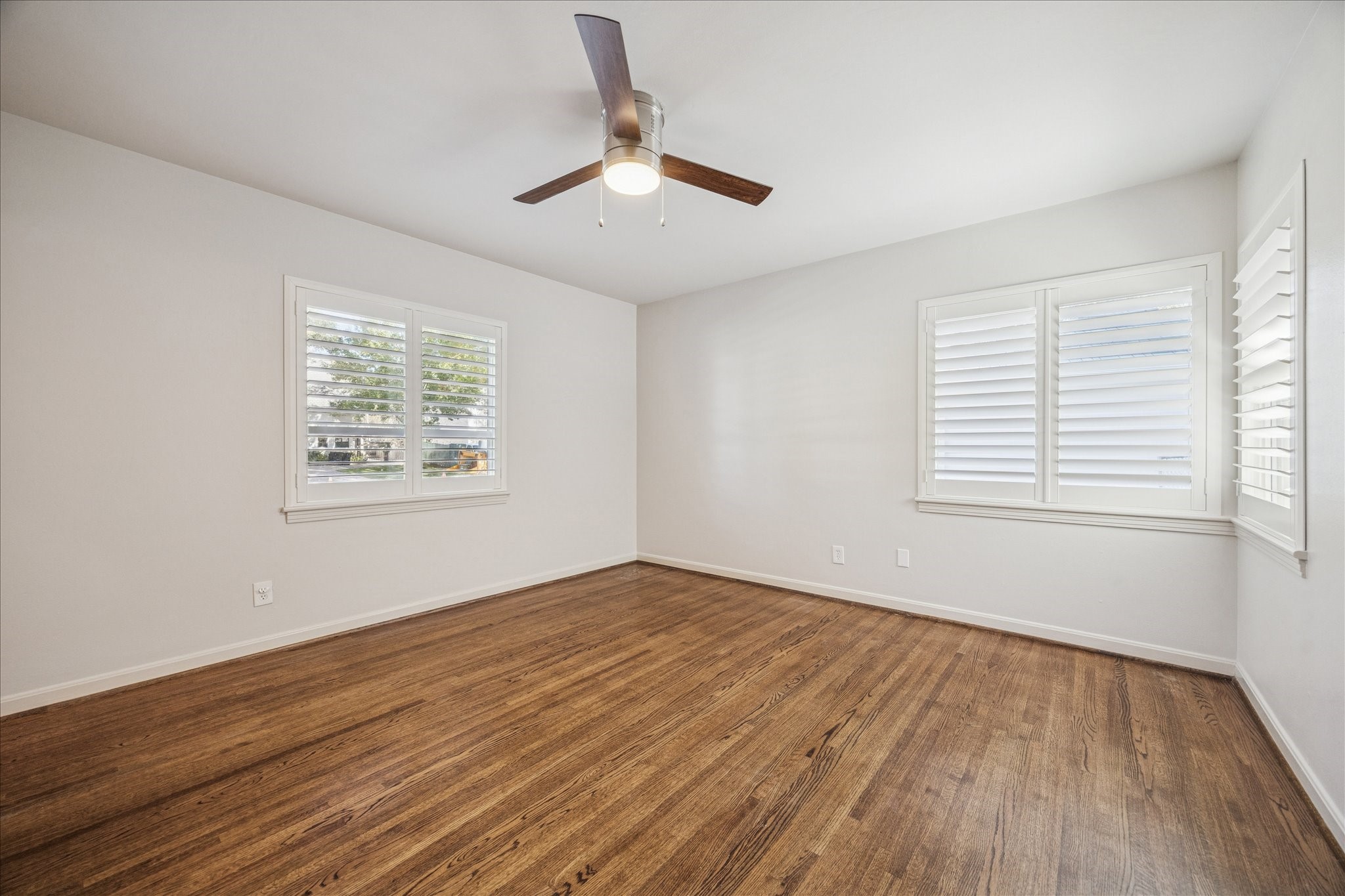 547 3 Corners Drive Hunters Creek Village, TX 77024 - Photo 9 of 17 a view of an empty room with wooden floor and a window