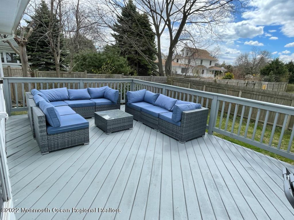 a view of roof deck with couches and wooden floor