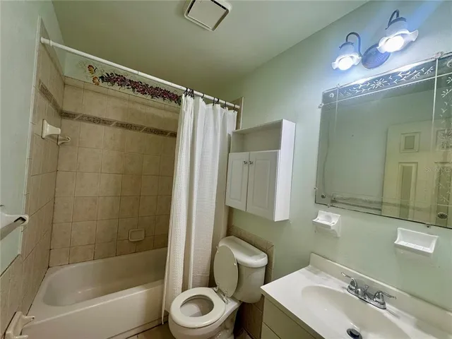 a bathroom with a sink mirror toilet and bathtub