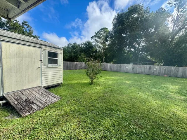 a view of a backyard with a small cabin
