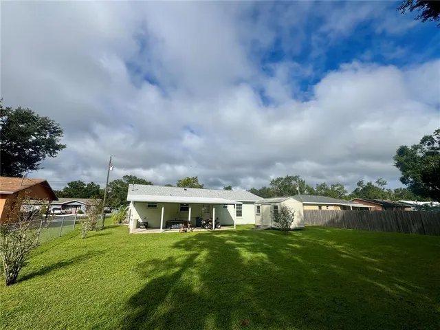 a view of house with garden and bench