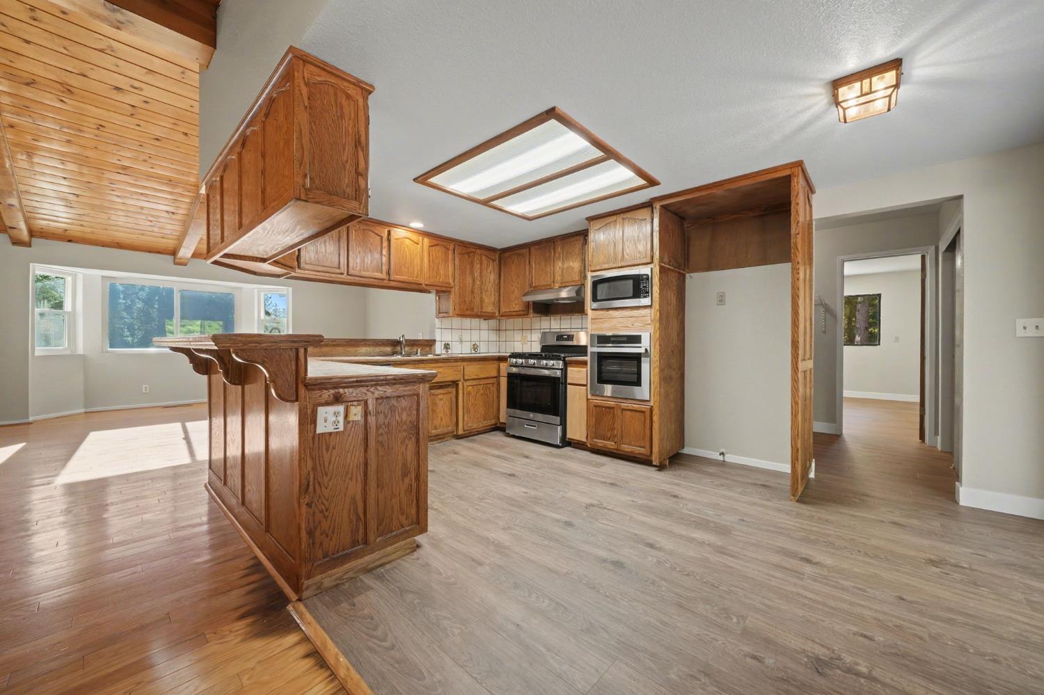 23781 Golden Ridge Drive Volcano, CA 95689 - Photo 19 of 50 a kitchen with stainless steel appliances granite countertop a refrigerator and a stove top oven