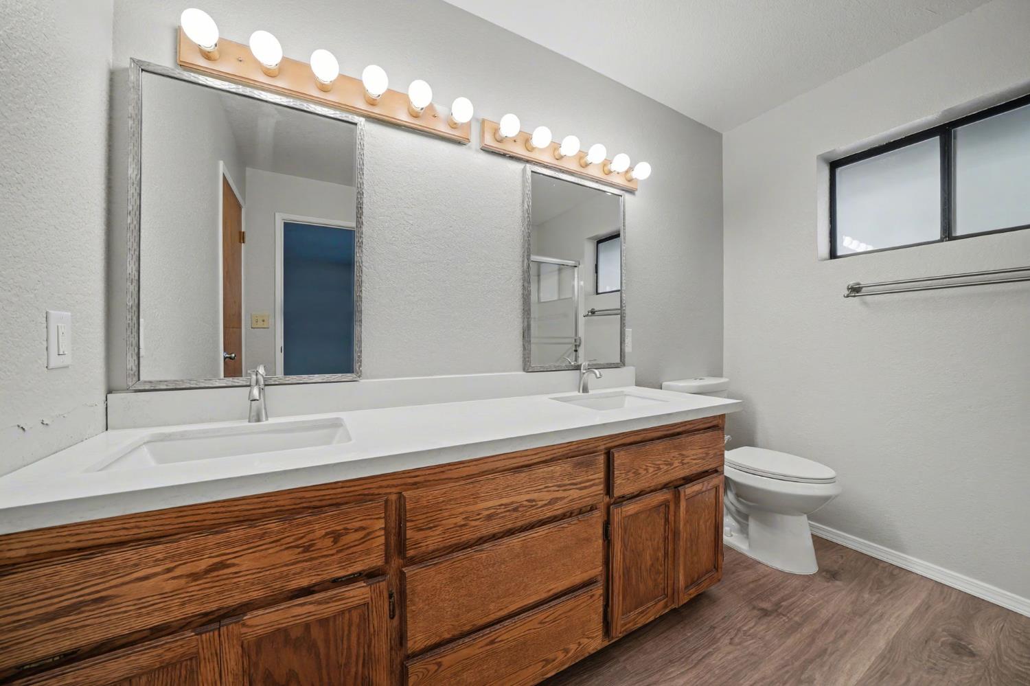 23781 Golden Ridge Drive Volcano, CA 95689 - Photo 29 of 50 a bathroom with a double vanity sink and a toilet