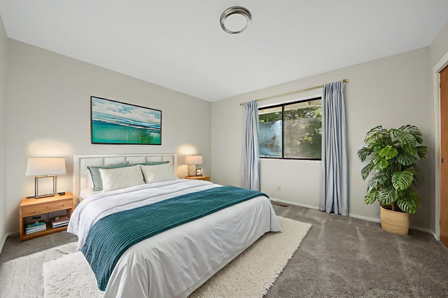 23781 Golden Ridge Drive Volcano, CA 95689 - Photo 31 of 50 a bedroom with a large bed potted plant and a window