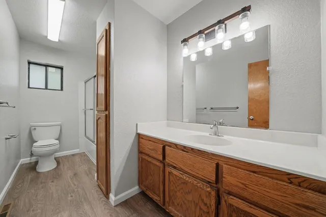 a bathroom with a toilet sink and mirror