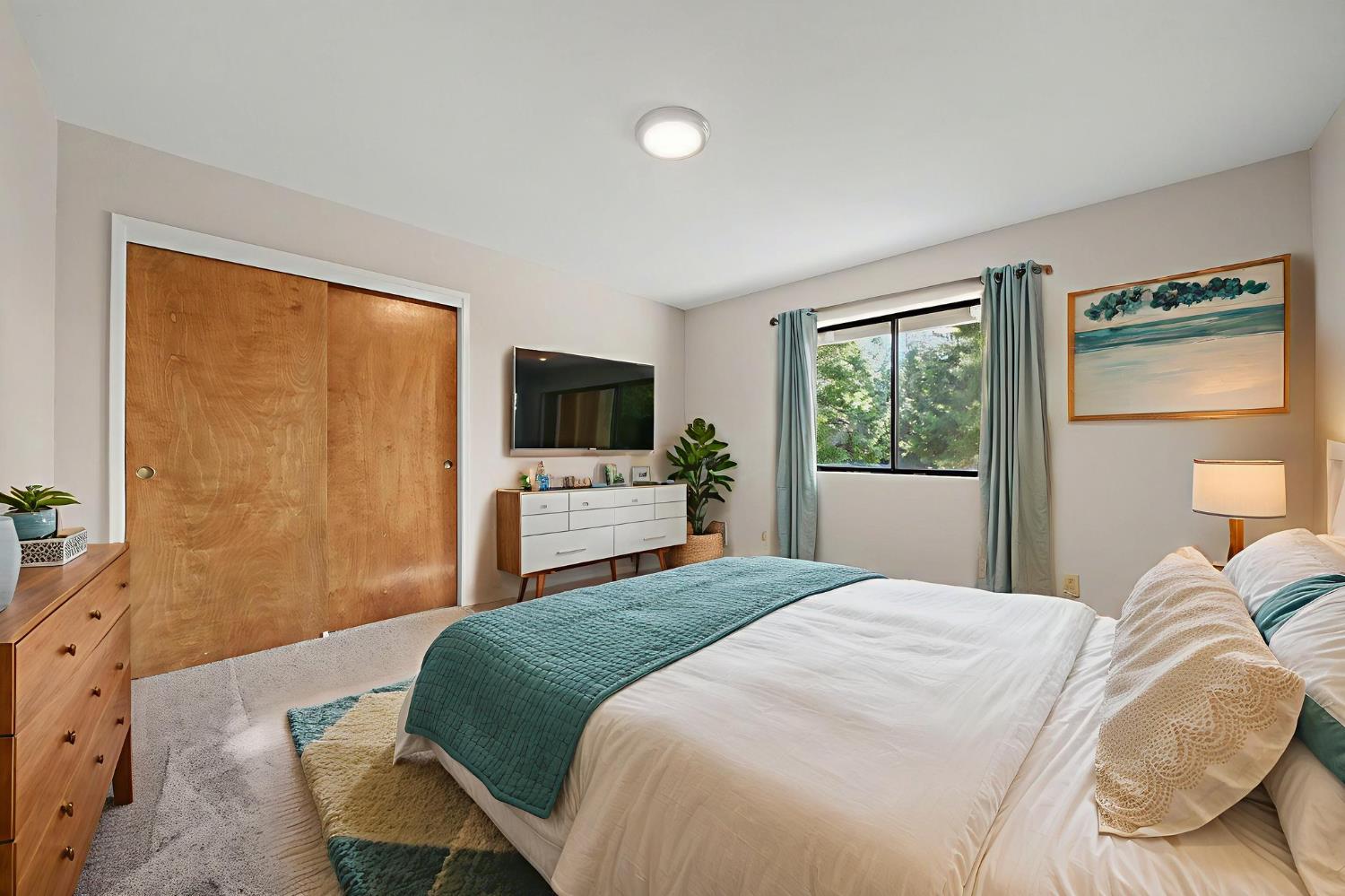 23781 Golden Ridge Drive Volcano, CA 95689 - Photo 36 of 50 a bedroom with a bed and a flat tv screen on dresser