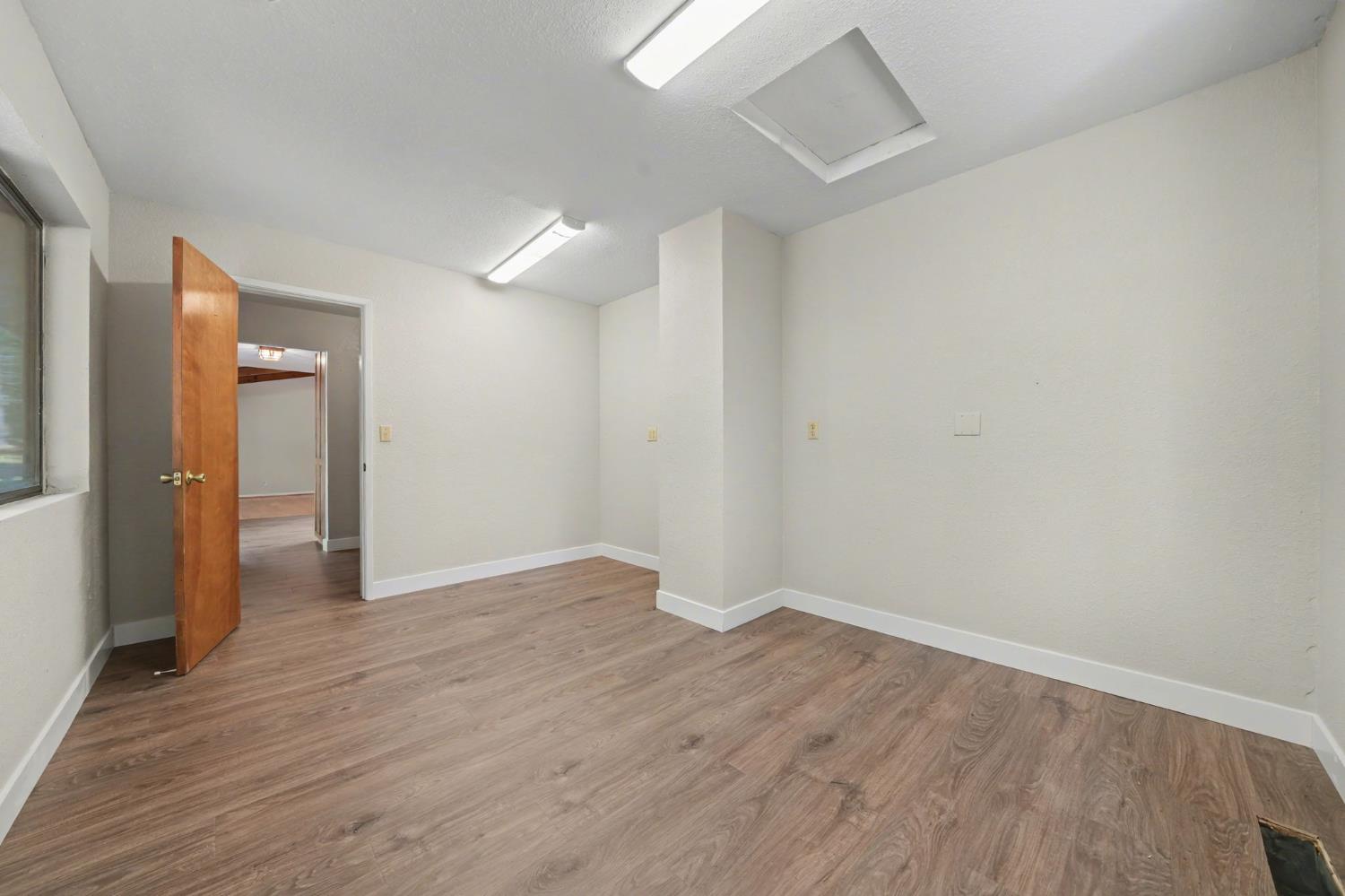 23781 Golden Ridge Drive Volcano, CA 95689 - Photo 42 of 50 a view of an empty room with wooden floor