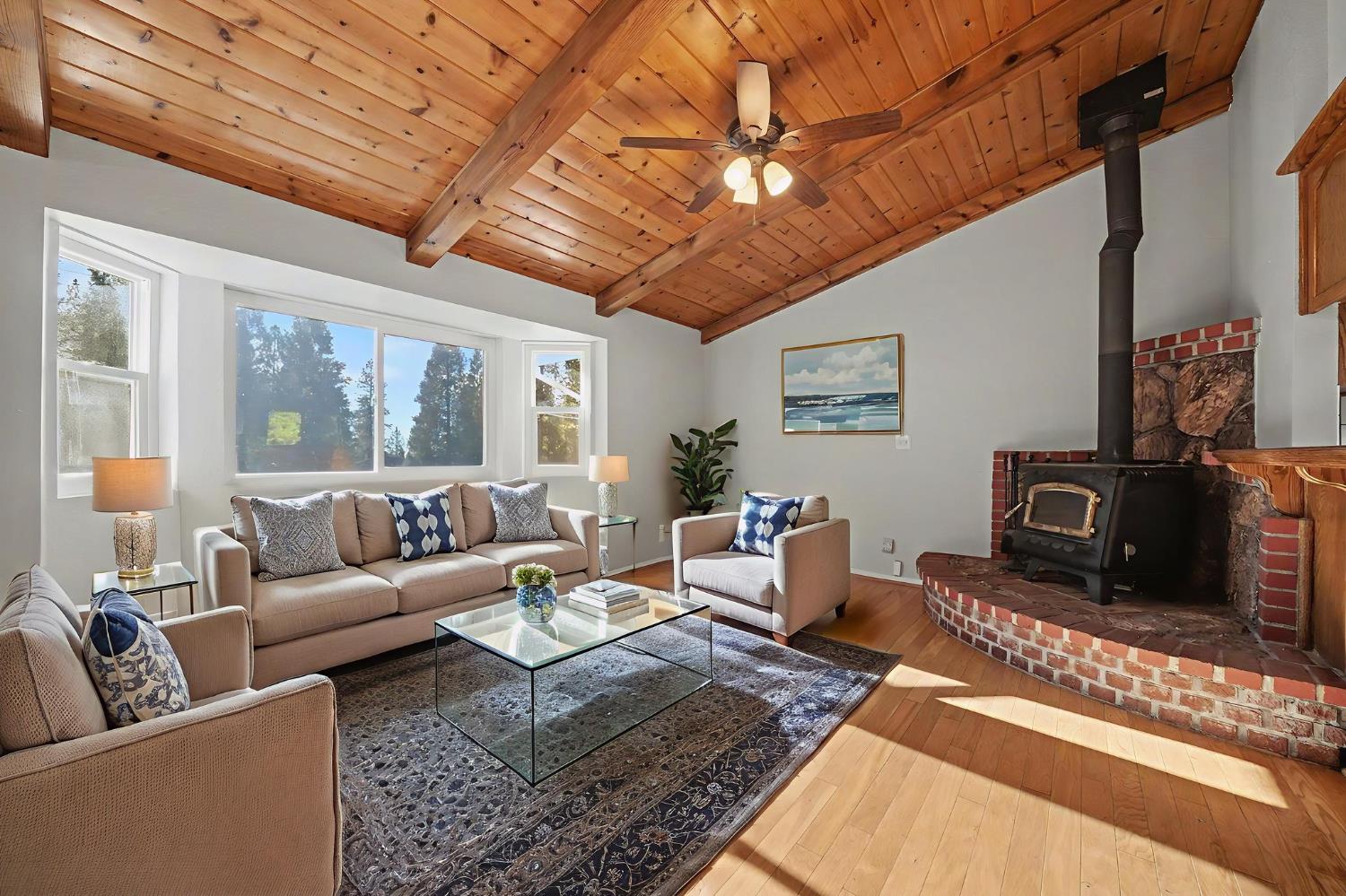 23781 Golden Ridge Drive Volcano, CA 95689 - Photo 10 of 50 a living room with furniture a rug potted plant and a large window