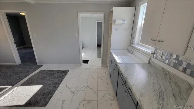 a kitchen with stainless steel appliances a refrigerator and window