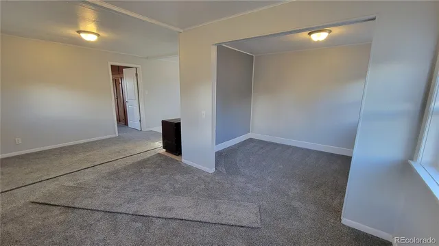 an empty room with windows and entrance