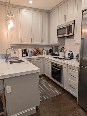 a kitchen with a sink stove and microwave