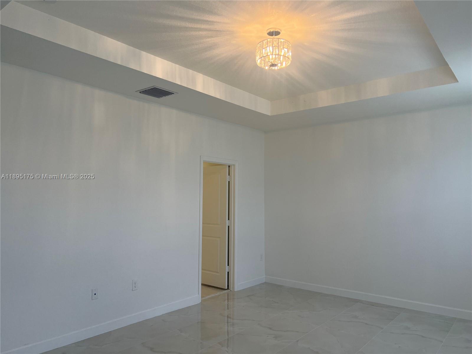 16960 Southwest 288th Terrace, Unit 16960 Homestead, FL 33033 - Photo 11 of 33 a view of a chandelier fan