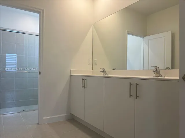 a bathroom with a glass door shower