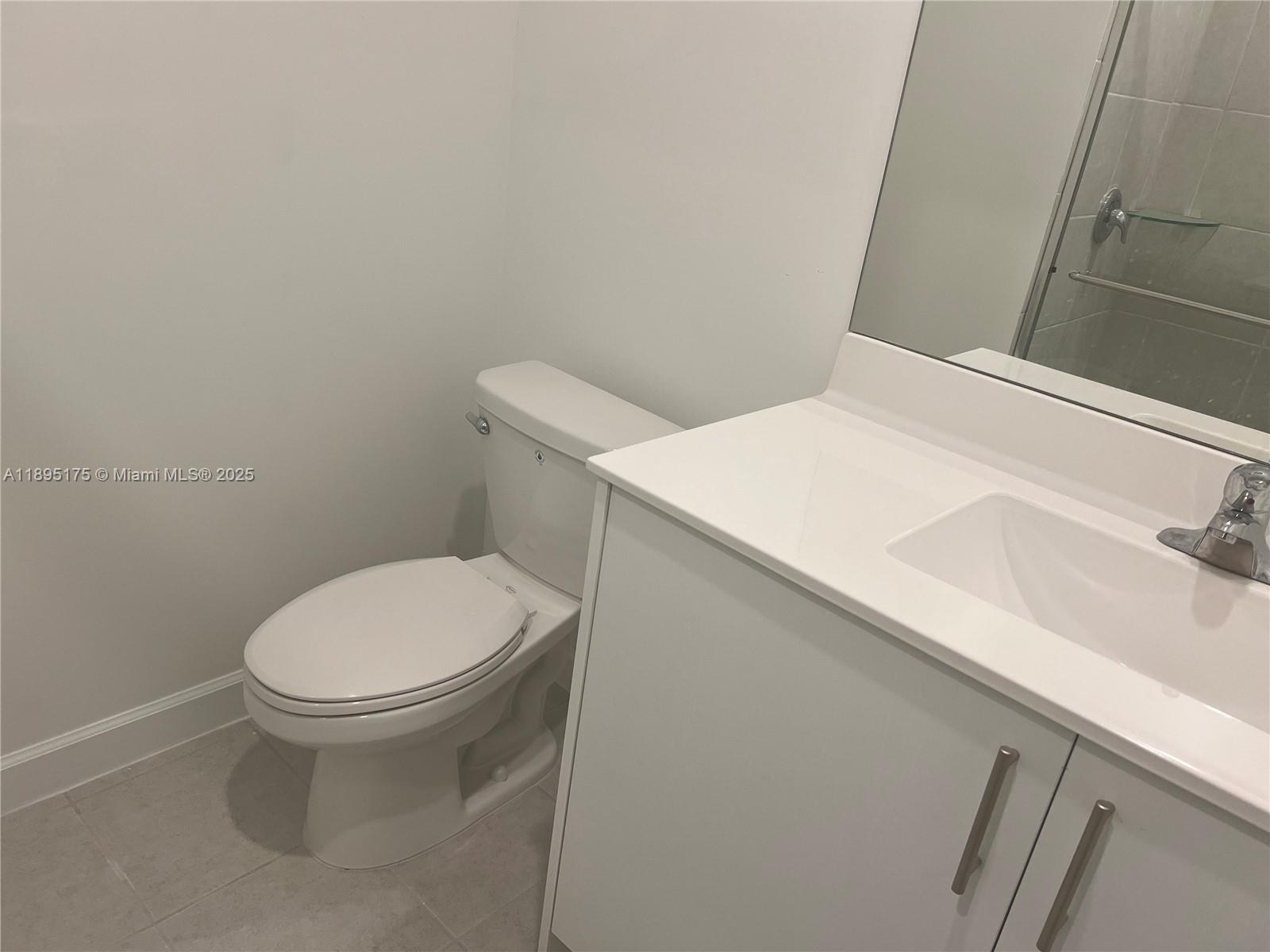 16960 Southwest 288th Terrace, Unit 16960 Homestead, FL 33033 - Photo 20 of 33 a white toilet sitting next to a white sink