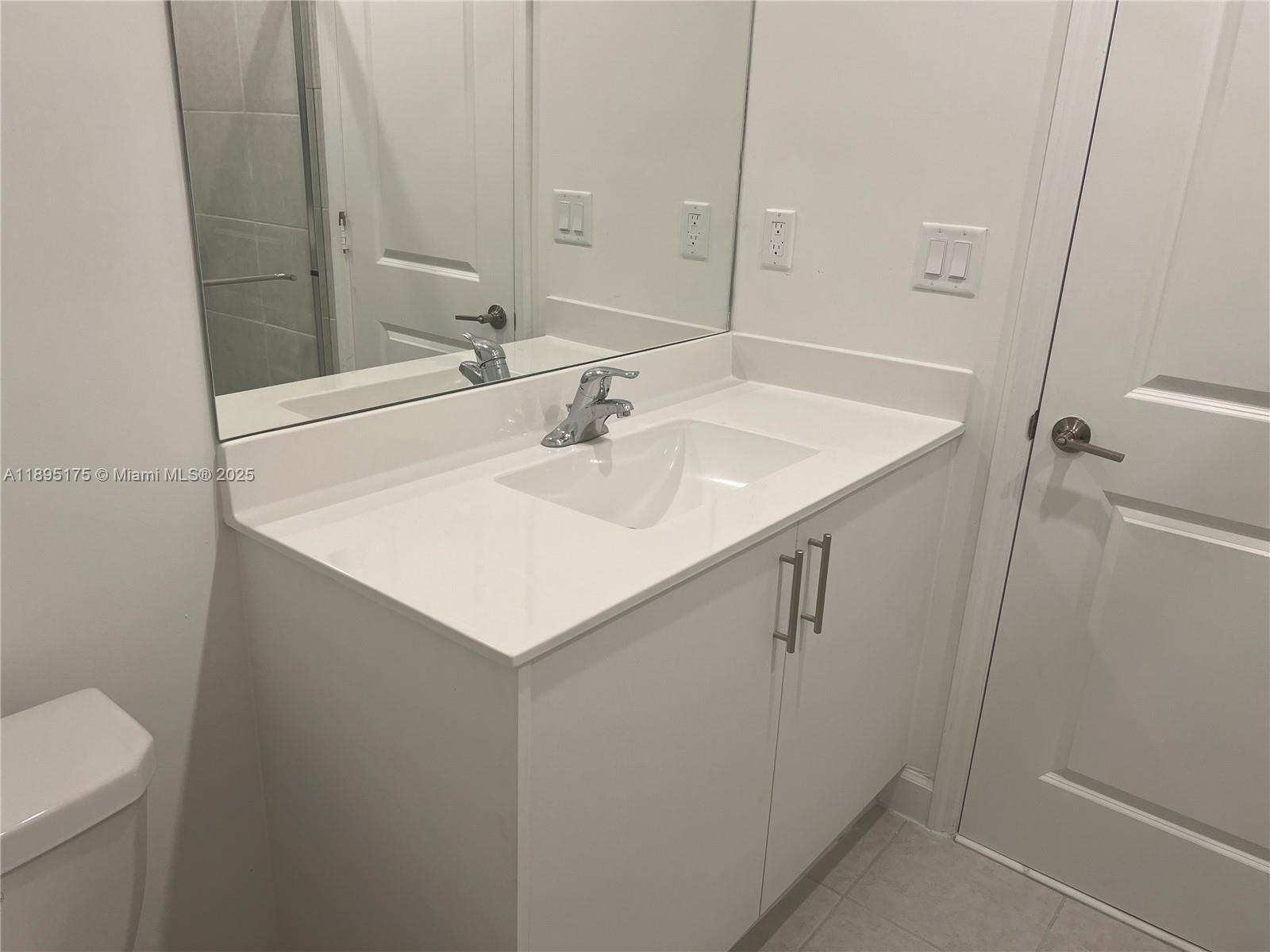 16960 Southwest 288th Terrace, Unit 16960 Homestead, FL 33033 - Photo 21 of 33 a bathroom with a sink and a mirror