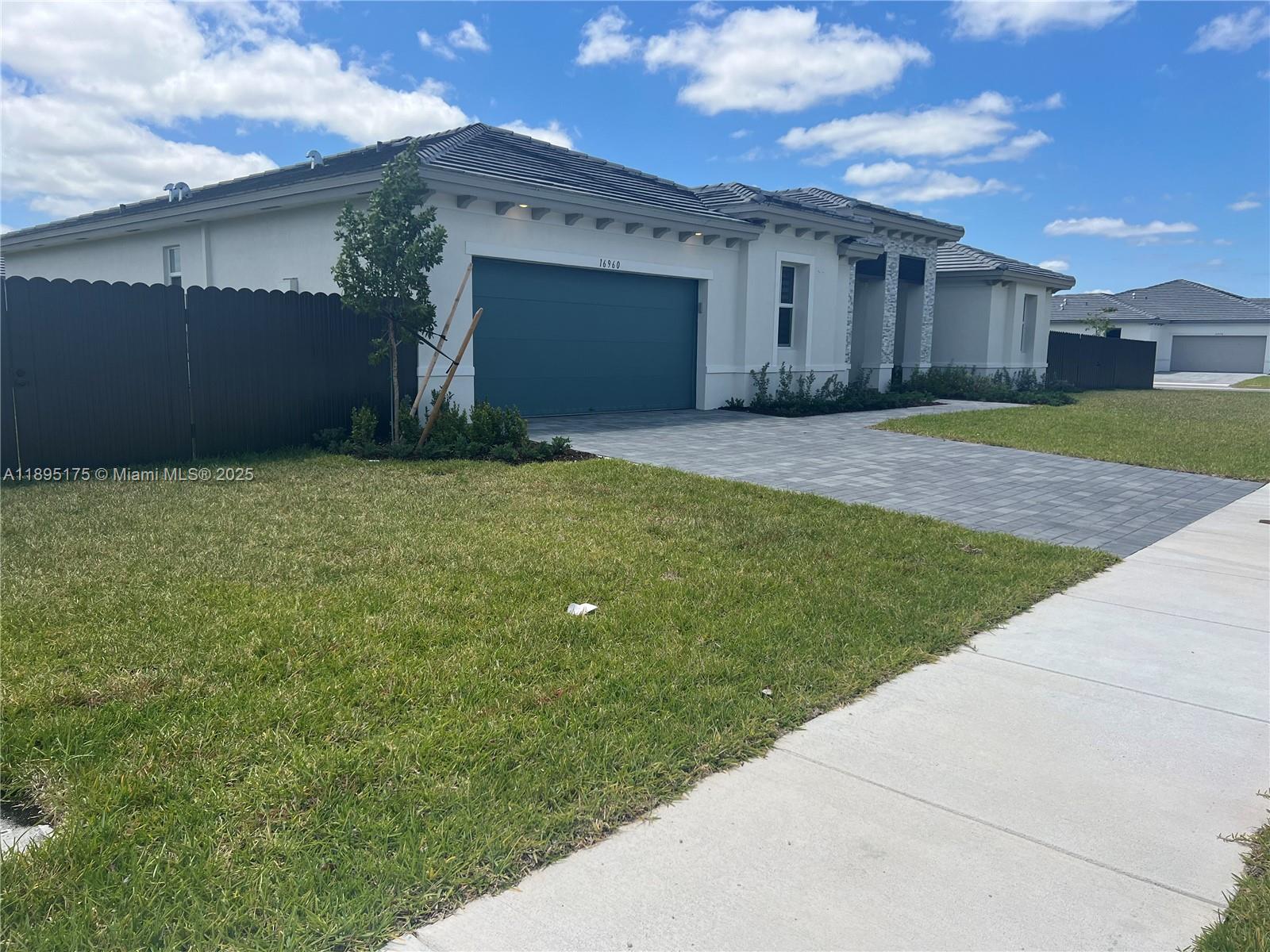 16960 Southwest 288th Terrace, Unit 16960 Homestead, FL 33033 - Photo 31 of 33 a front view of house with yard
