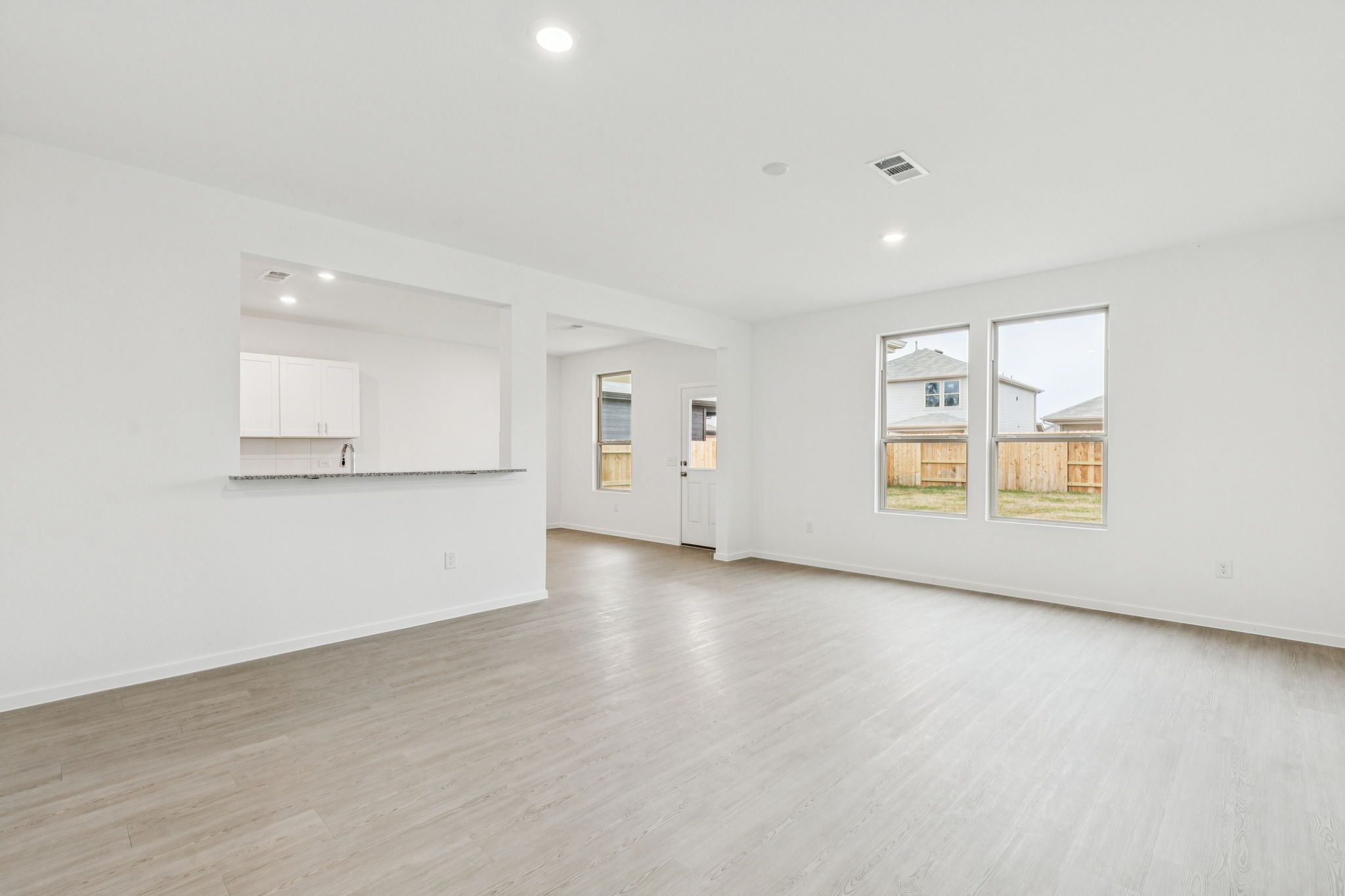 16148 Sepia Manor Street Conroe, TX 77302 - Photo 5 of 32 an empty room with wooden floor and windows