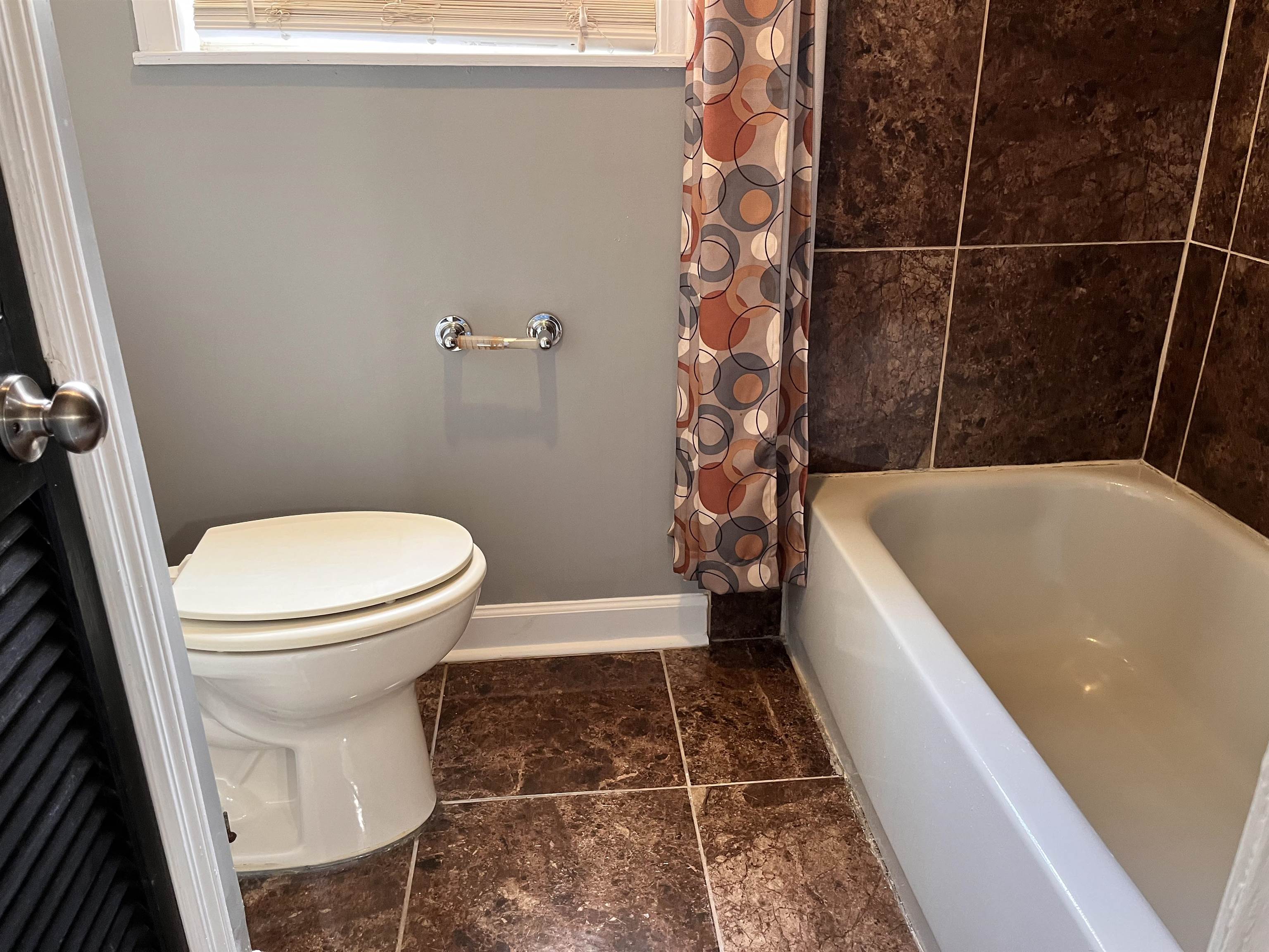 4282 Millbranch Road Memphis, TN 38116 - Photo 14 of 28 Bathroom with toilet and shower / bath combination with curtain